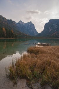 Scenic view of lake by mountains against sky