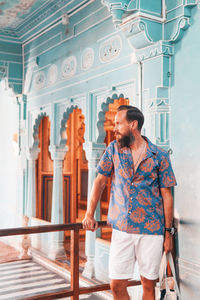 Thoughtful man standing against wall