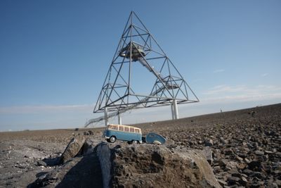 Low angle view of text on land against clear blue sky