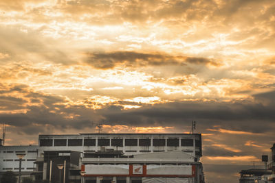 Low angle view of building against dramatic sky