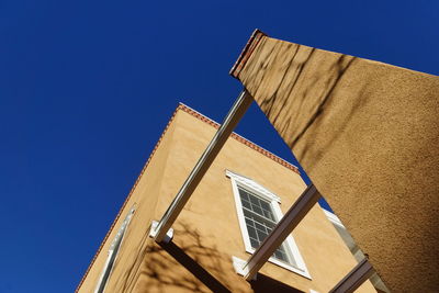 Low angle view of building against clear blue sky