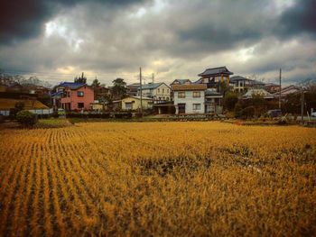 View of rural landscape against cloudy sky