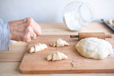 Close-up of man preparing food on cutting board