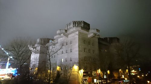 View of historic building at night during winter