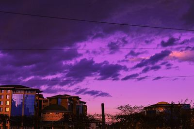 Low angle view of buildings against sky at dusk