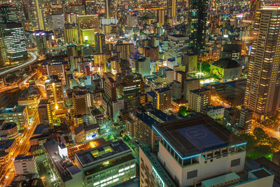 High angle view of illuminated city buildings at night