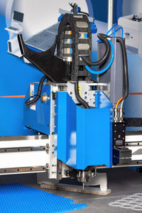An advanced cutting machine engages in precision work within a modern manufacturing environment.