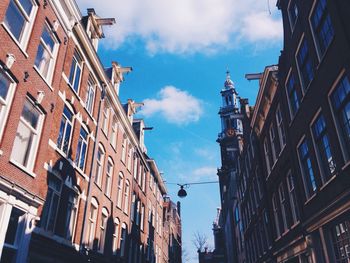 Low angle view of building against cloudy sky