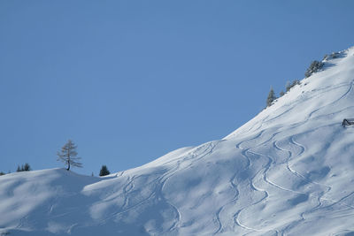 Snowcapped mountains against clear blue sky