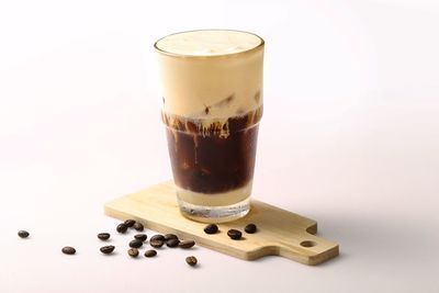 Close-up of coffee cup on table against white background