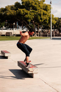 Boy doing skateboard trick on rail