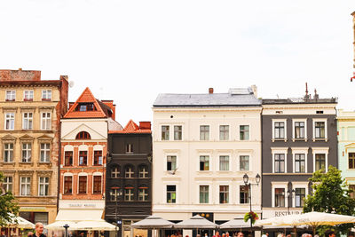 Buildings in city against clear sky