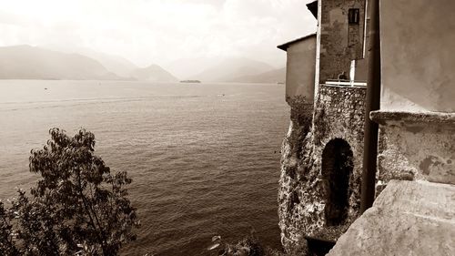 Scenic view of sea by buildings against sky