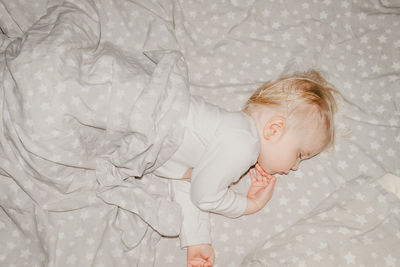 High angle view of baby boy sleeping on bed