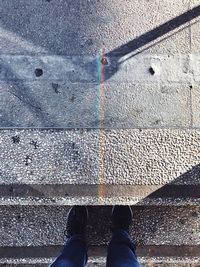 Low section of man standing on water