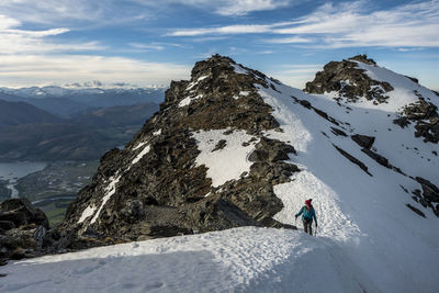 Alpine hiking in snow covered mountains, the remarkables, new zealand