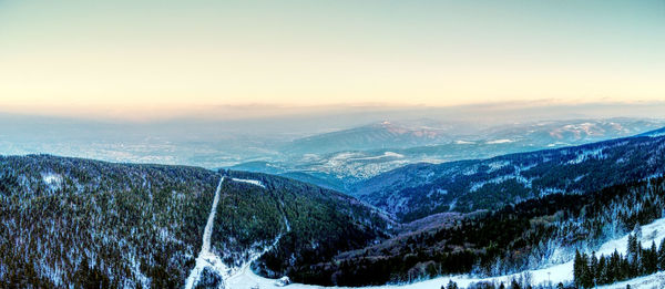 Scenic view of snowcapped mountains against sky during winter