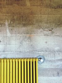 Yellow radiator against wall