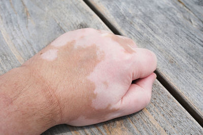 Cropped hand of man on wooden table