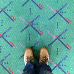 Low section of person standing on tiled floor