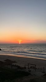 Scenic view of sea against clear sky during sunset