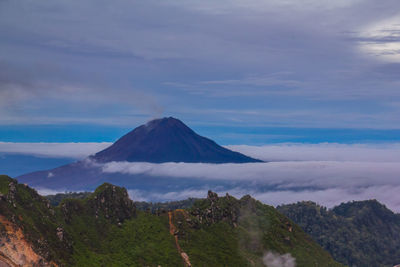 Panoramic view of volcanic landscape against cloudy sky