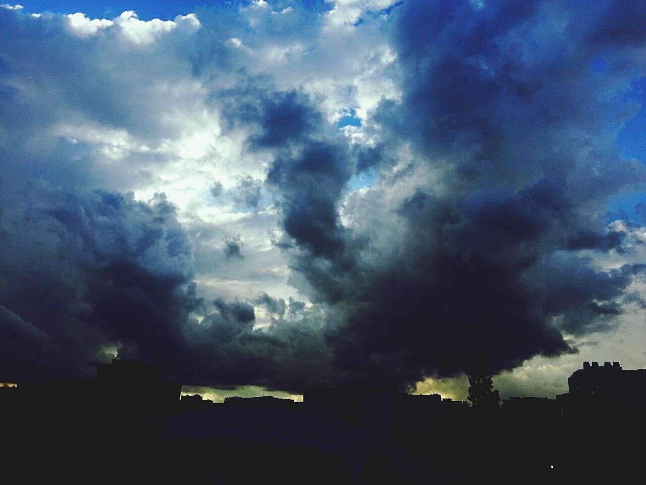 sky, cloud - sky, cloudy, weather, storm cloud, building exterior, silhouette, built structure, cloud, architecture, dramatic sky, dusk, low angle view, blue, nature, overcast, beauty in nature, cloudscape, atmospheric mood, scenics