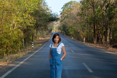 Portrait of woman standing on road 