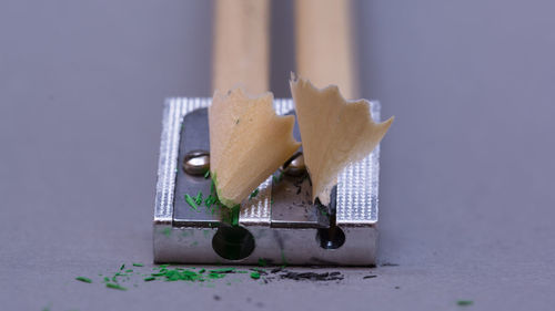 Close-up of pencil shavings on sharpener on table