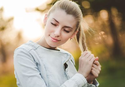 Portrait of young woman touching hair