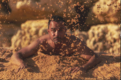 Portrait of shirtless man in water