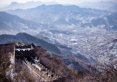 High angle view of townscape by mountains against sky