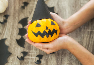 Close-up of person hand holding pumpkin