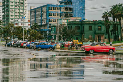 Cars on street by buildings in city