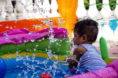 Baby girl playing in wadding pool