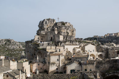 Buildings in city against clear sky