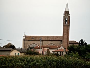 Clock tower amidst buildings against sky