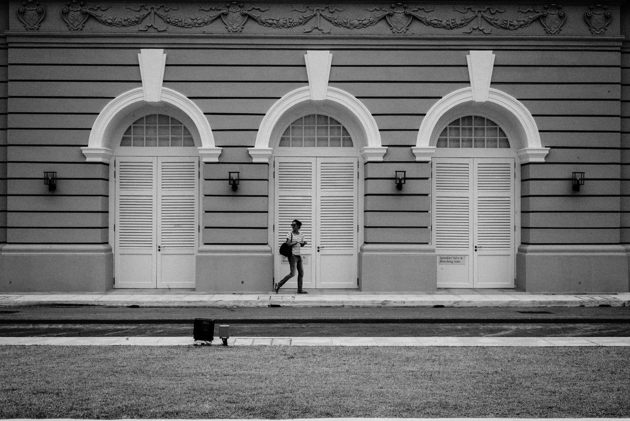 building exterior, architecture, built structure, walking, street, full length, men, lifestyles, window, building, city, person, cobblestone, leisure activity, day, sidewalk, city life, bicycle