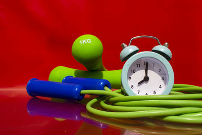 Close-up of multi colored candies on table against red background