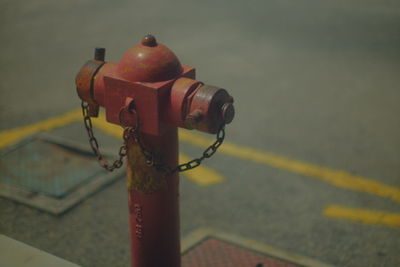 Close-up of fire hydrant on street against wall