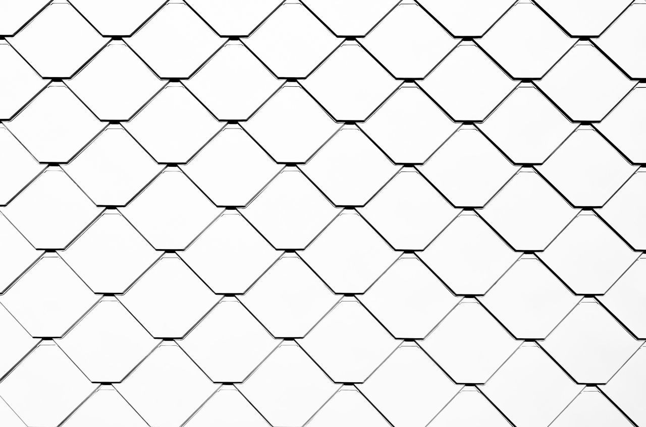 LOW ANGLE VIEW OF CHAINLINK FENCE AGAINST SKY