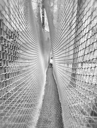 Rear view of man walking on bridge