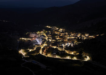 Mountain village from above, night photography, light trails, long exposure, mountain and roads