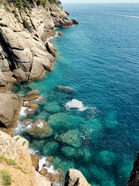 High angle view of rocks on sea shore