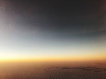 Scenic view of desert against clear sky at sunset