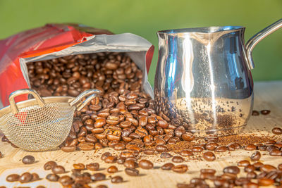 Close-up of coffee beans in jar on table