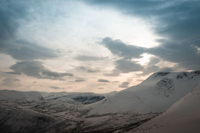Scenic view of snowcapped mountains against sky during sunset