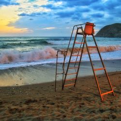 Lifeguard hut on beach against sky