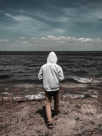 Rear view of boy standing on beach