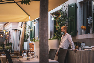 Woman standing in front of restaurant